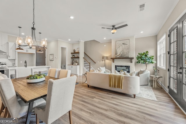 937 Willingham Dr Unit 7, Hapeville, GA 30354 - dining room featuring recessed lighting, ornamental molding, light wood-type flooring, a large fireplace, and a ceiling fan