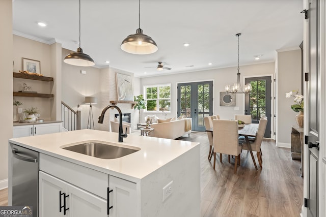 937 Willingham Dr Unit 7, Hapeville, GA 30354 - kitchen featuring light wood finished floors, crown molding, open floor plan, recessed lighting, and french doors