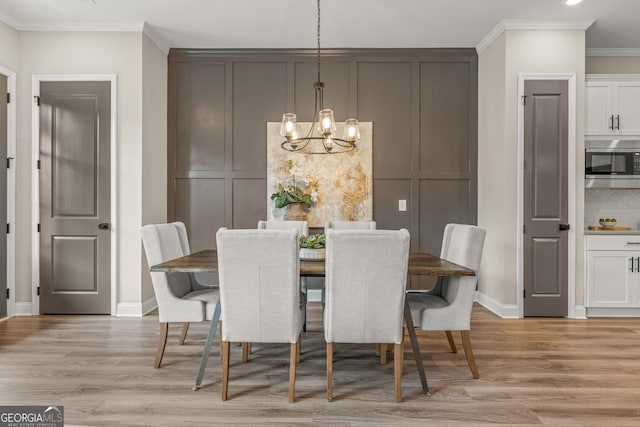 937 Willingham Dr Unit 7, Hapeville, GA 30354 - dining area featuring a chandelier, light wood finished floors, and ornamental molding
