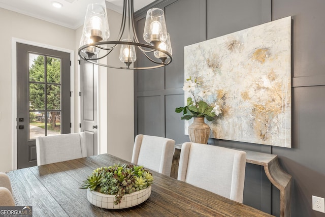 937 Willingham Dr Unit 7, Hapeville, GA 30354 - dining space featuring a chandelier, ornamental molding, and a decorative wall