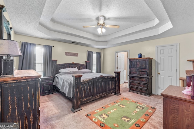 603 Rossie Ct, Mcdonough, GA 30252 - bedroom featuring a raised ceiling, carpet flooring, a textured ceiling, and a ceiling fan