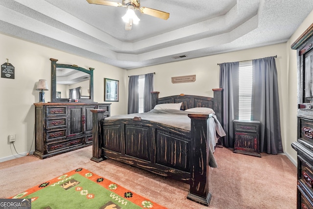 603 Rossie Ct, Mcdonough, GA 30252 - bedroom featuring light colored carpet, a raised ceiling, a textured ceiling, and ceiling fan
