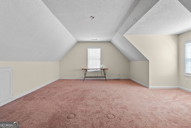 603 Rossie Ct, Mcdonough, GA 30252 - bonus room featuring a textured ceiling, carpet floors, plenty of natural light, and vaulted ceiling
