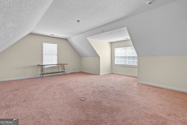603 Rossie Ct, Mcdonough, GA 30252 - bonus room with vaulted ceiling, carpet flooring, and a textured ceiling