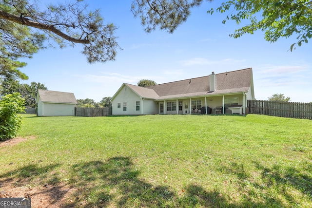 603 Rossie Ct, Mcdonough, GA 30252 - rear view of house with a fenced backyard, a chimney, and an outdoor structure