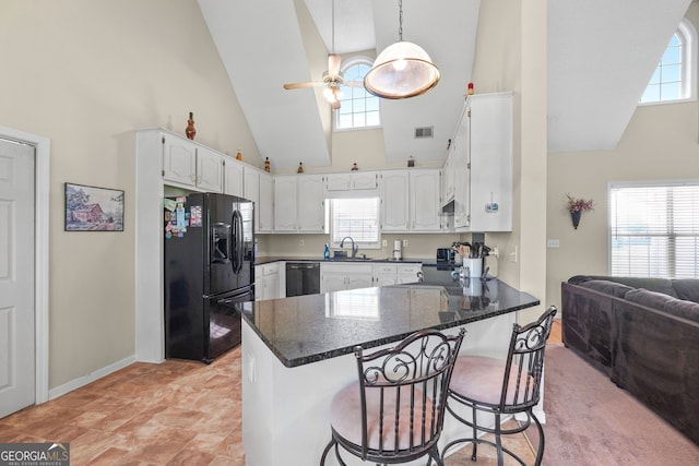 603 Rossie Ct, Mcdonough, GA 30252 - kitchen featuring black appliances, high vaulted ceiling, a peninsula, a ceiling fan, and white cabinetry