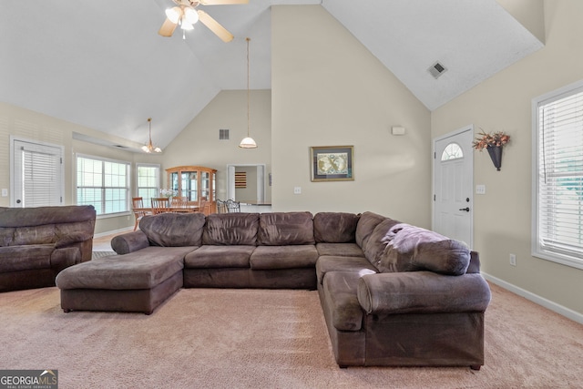 603 Rossie Ct, Mcdonough, GA 30252 - carpeted living room with ceiling fan, high vaulted ceiling, and plenty of natural light