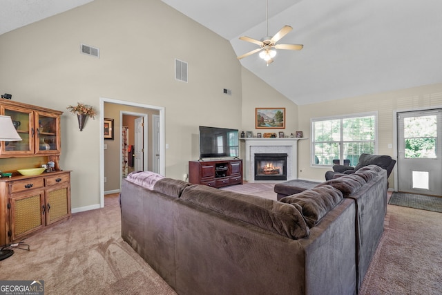 603 Rossie Ct, Mcdonough, GA 30252 - living area with light carpet, high vaulted ceiling, a glass covered fireplace, and ceiling fan