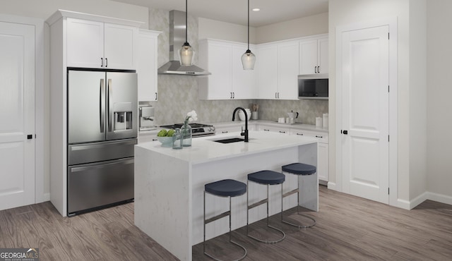 927 Willingham Dr Unit 12, Hapeville, GA 30354 - kitchen featuring stainless steel appliances, wall chimney range hood, decorative backsplash, wood finished floors, and recessed lighting