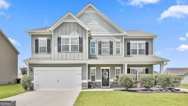 17 October Ave, Newnan, GA 30265 - craftsman house with board and batten siding, a front yard, driveway, an attached garage, and a porch