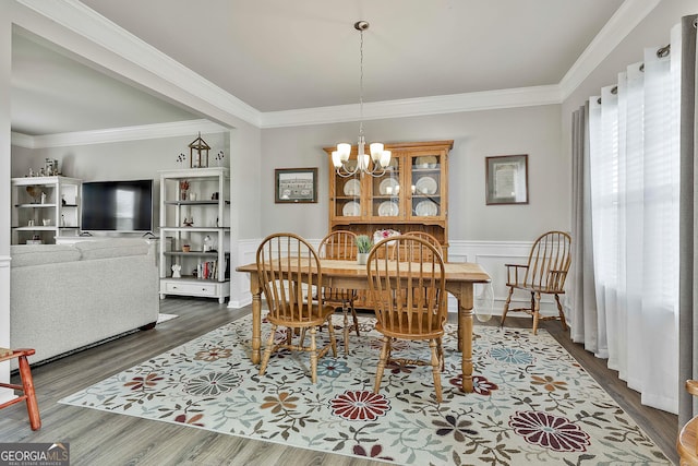 17 October Ave, Newnan, GA 30265 - dining space with a chandelier, dark wood-style floors, ornamental molding, and wainscoting