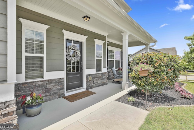 17 October Ave, Newnan, GA 30265 - doorway to property with covered porch and stone siding