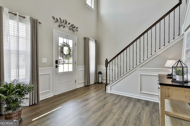 17 October Ave, Newnan, GA 30265 - foyer with a wainscoted wall, stairway, wood finished floors, a towering ceiling, and a decorative wall