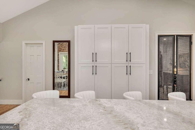 106 Draughons Dr, Saint Simons, GA 31522 - bedroom featuring wood finished floors and lofted ceiling