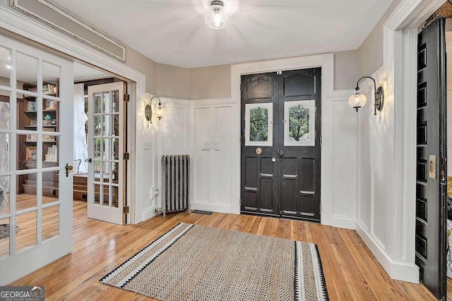 106 Draughons Dr, Saint Simons, GA 31522 - foyer with radiator, wood finished floors, and french doors