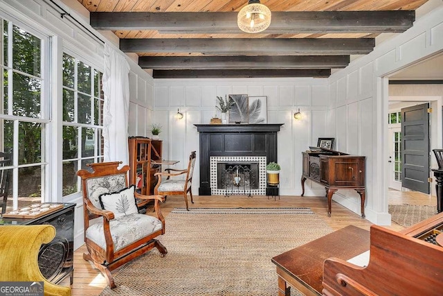 106 Draughons Dr, Saint Simons, GA 31522 - living room with wood finished floors, a fireplace, a decorative wall, and a wood ceiling with exposed beams
