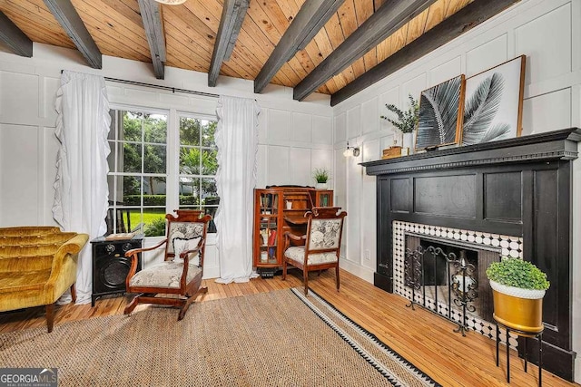 106 Draughons Dr, Saint Simons, GA 31522 - living area with a decorative wall, wood finished floors, a wood ceiling with exposed beams, and a fireplace