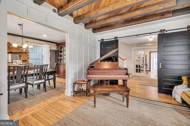 106 Draughons Dr, Saint Simons, GA 31522 - living area featuring a barn door, hardwood / wood-style flooring, beamed ceiling, and a chandelier