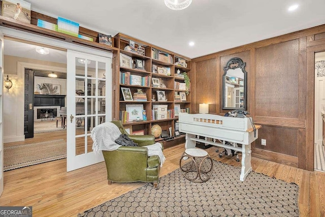 106 Draughons Dr, Saint Simons, GA 31522 - living area with light wood-style floors, wooden walls, and a fireplace