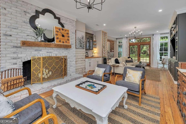 106 Draughons Dr, Saint Simons, GA 31522 - living area featuring a chandelier, light wood-style floors, a fireplace, and recessed lighting
