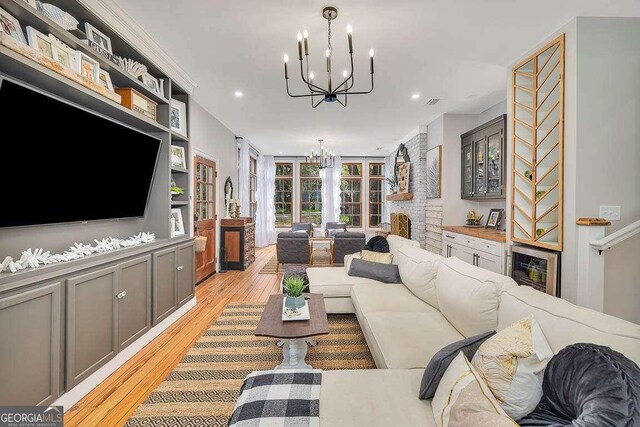 106 Draughons Dr, Saint Simons, GA 31522 - living area with a chandelier, a brick fireplace, light wood finished floors, and recessed lighting