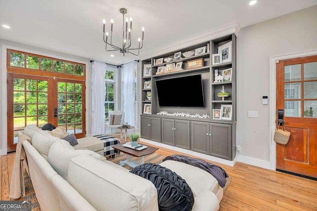106 Draughons Dr, Saint Simons, GA 31522 - living room featuring light wood-style flooring, french doors, a chandelier, recessed lighting, and plenty of natural light