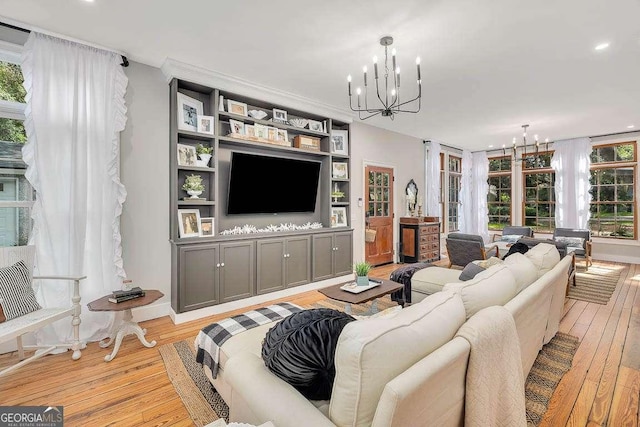 106 Draughons Dr, Saint Simons, GA 31522 - living room featuring a chandelier, light wood-type flooring, recessed lighting, crown molding, and french doors