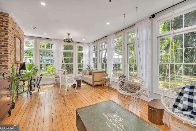 106 Draughons Dr, Saint Simons, GA 31522 - sunroom / solarium featuring hardwood / wood-style flooring, french doors, plenty of natural light, a chandelier, and recessed lighting