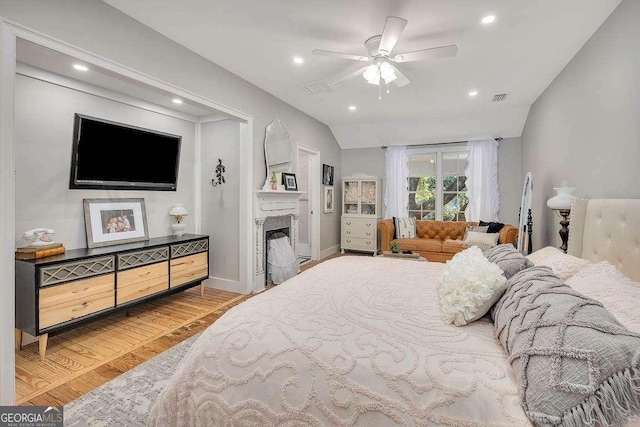106 Draughons Dr, Saint Simons, GA 31522 - bedroom with wood finished floors, lofted ceiling, a fireplace, recessed lighting, and a ceiling fan