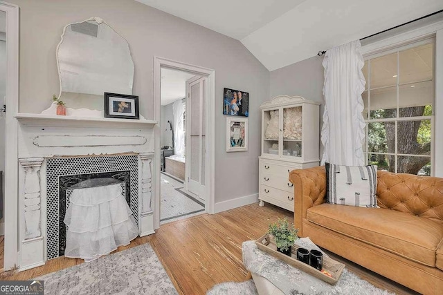 106 Draughons Dr, Saint Simons, GA 31522 - living room featuring lofted ceiling, wood finished floors, and a fireplace
