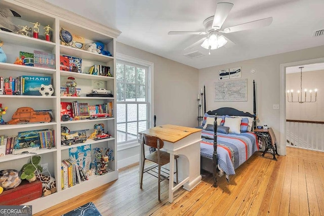 106 Draughons Dr, Saint Simons, GA 31522 - bedroom with light wood-type flooring, a chandelier, and ceiling fan