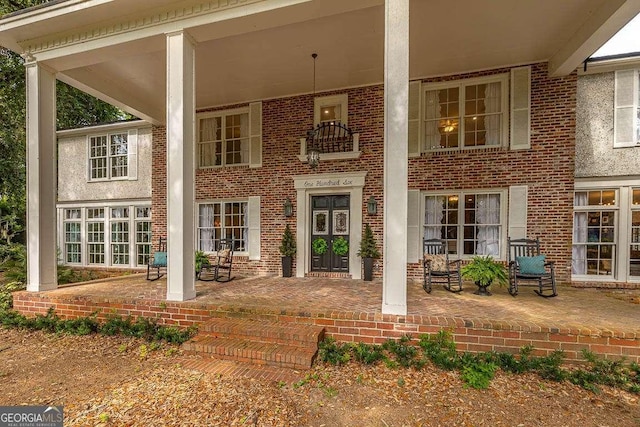 106 Draughons Dr, Saint Simons, GA 31522 - property entrance featuring a porch and brick siding