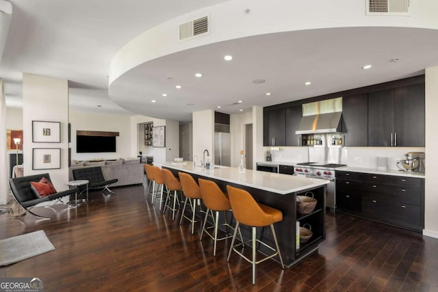 3325 Piedmont Rd NE Unit 2006, Atlanta, GA 30305 - kitchen featuring extractor fan, high end stove, a kitchen breakfast bar, open floor plan, and light countertops