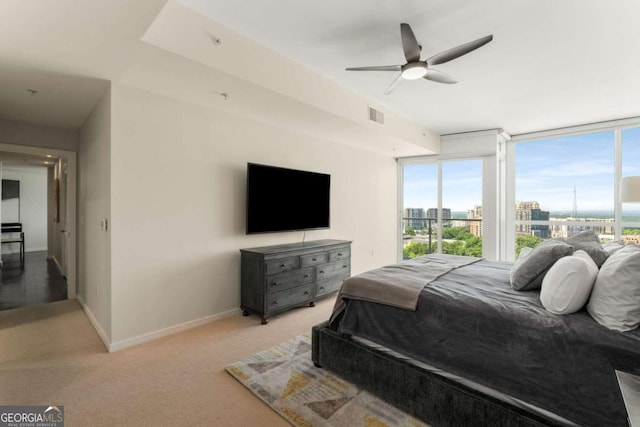 3325 Piedmont Rd NE Unit 2006, Atlanta, GA 30305 - bedroom featuring multiple windows, light carpet, and a ceiling fan