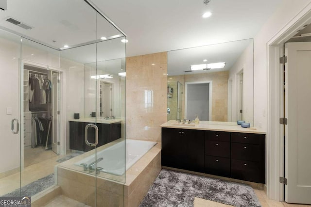 3325 Piedmont Rd NE Unit 2006, Atlanta, GA 30305 - full bathroom with vanity, a garden tub, a stall shower, recessed lighting, and a spacious closet