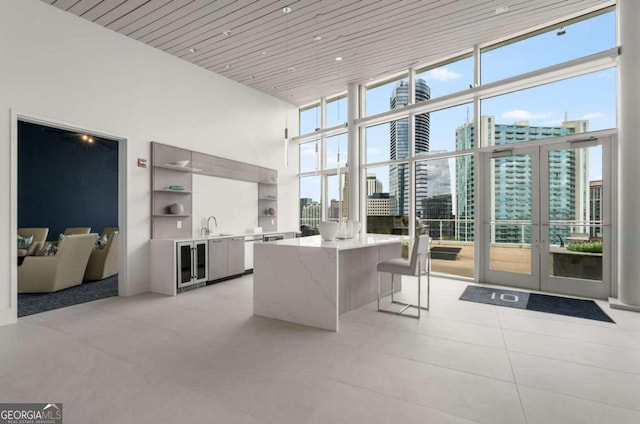 3325 Piedmont Rd NE Unit 2006, Atlanta, GA 30305 - living area with a high ceiling, wine cooler, a view of city, wood ceiling, and floor to ceiling windows