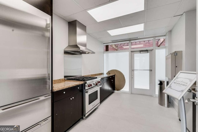 3325 Piedmont Rd NE Unit 2006, Atlanta, GA 30305 - kitchen with appliances with stainless steel finishes, wall chimney exhaust hood, a drop ceiling, and light stone countertops