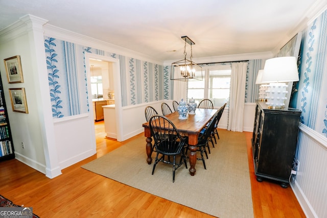 8 Crepe Myrtle, Newnan, GA 30263 - dining room featuring crown molding, light wood-type flooring, wallpapered walls, healthy amount of natural light, and a chandelier