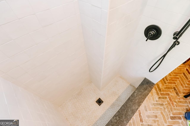 8 Crepe Myrtle, Newnan, GA 30263 - bathroom featuring tiled shower and brick flooring