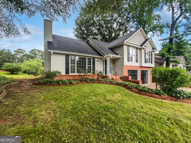 5021 Rodrick Trce, Marietta, GA 30066 - split level home featuring brick siding, a chimney, a front lawn, and roof with shingles