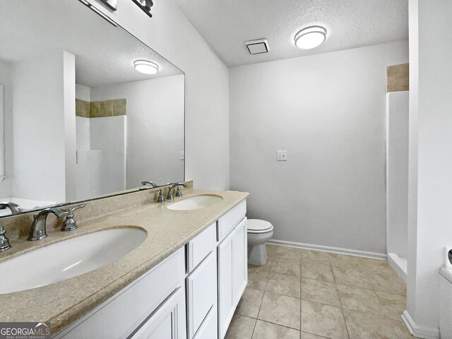 5021 Rodrick Trce, Marietta, GA 30066 - bathroom with double vanity, a textured ceiling, and a shower