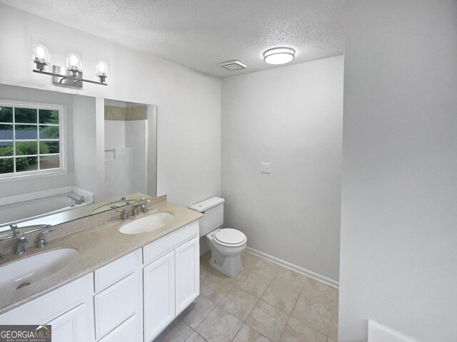 5021 Rodrick Trce, Marietta, GA 30066 - bathroom with a textured ceiling, a garden tub, double vanity, and tile patterned floors