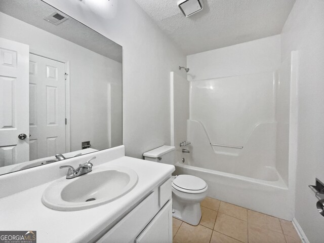 5021 Rodrick Trce, Marietta, GA 30066 - full bathroom with a textured ceiling, vanity, washtub / shower combination, and tile patterned floors