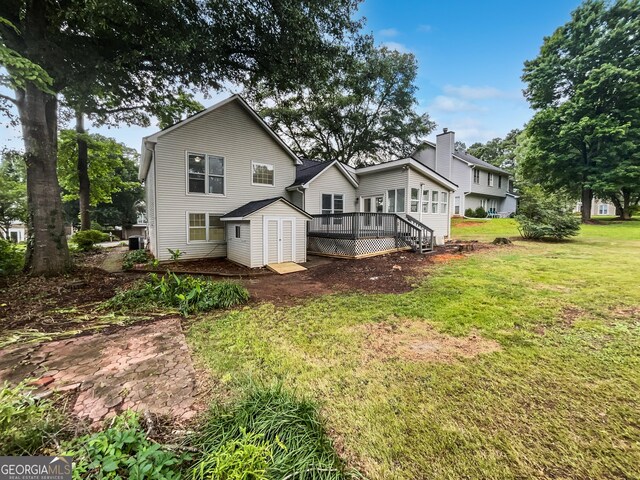 5021 Rodrick Trce, Marietta, GA 30066 - back of property with a shed, a deck, and a lawn