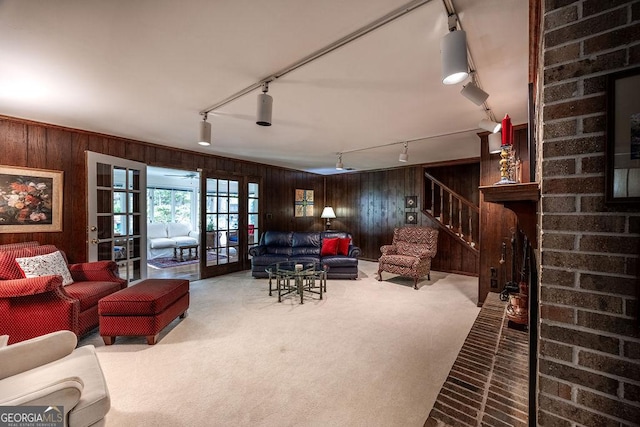 205 Castlegate Rd, Macon, GA 31210 - living area featuring rail lighting, wooden walls, carpet floors, and french doors