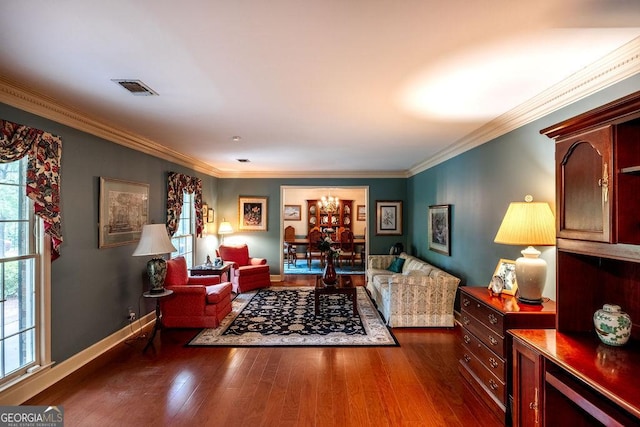 205 Castlegate Rd, Macon, GA 31210 - living room featuring plenty of natural light, ornamental molding, dark wood-style flooring, and a chandelier