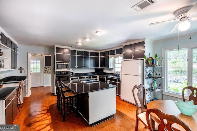 205 Castlegate Rd, Macon, GA 31210 - kitchen with black appliances, dark countertops, light wood-style floors, ceiling fan, and open shelves