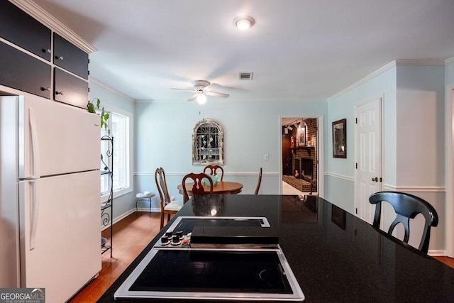 205 Castlegate Rd, Macon, GA 31210 - kitchen featuring freestanding refrigerator, black electric stovetop, a ceiling fan, dark countertops, and crown molding