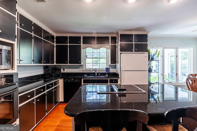 205 Castlegate Rd, Macon, GA 31210 - kitchen with stainless steel appliances, crown molding, dark cabinets, light wood-type flooring, and open shelves