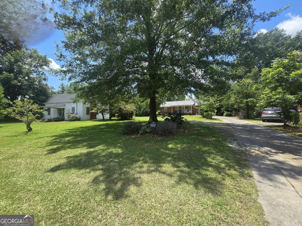 5061 Old Atlanta Rd, Hampton, GA 30228 - obstructed view of property featuring concrete driveway and a front yard